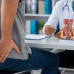Piles Doctor in Indore examining a patient with bleeding piles for advanced piles treatment