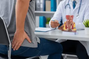 Piles Doctor in Indore examining a patient with bleeding piles for advanced piles treatment